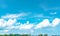 Beautiful blue sky and white cumulus clouds against coconut tree and mountain in happy and chill out day.