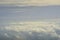 Beautiful blue sky with white puffy clouds in two levels with clear sky in between. Amazing view from airplane window taken up in