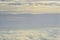 Beautiful blue sky with white puffy clouds in two levels with clear sky in between. Amazing view from airplane window taken up in