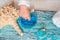 Beautiful blue spa composition. blue sea salt, liquid soap, starfish, shells and a white bath towel