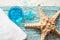 Beautiful blue spa composition. blue sea salt, liquid soap, starfish, shells and a white bath towel