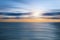 Beautiful blurred seascape background. The majestic sunset sky