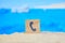 Beautiful blurred view of the beach with sand and tedefon sign as a symbol for calling and communication, ordering a tour,