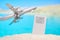 Beautiful blurred view of the beach and with a toy airplane near tickets in the sand. Travel and vacation concept