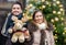 Beautiful blurry couple holding out reindeer toy for christmas