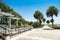 Beautiful boardwalk leading to the ocean, palm trees along the footpath.