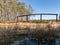 Beautiful bog landscape, curved wooden bridge over ditch