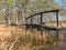 Beautiful bog landscape, curved wooden bridge over ditch