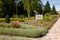 Beautiful botanical park or garden with different bushes, flowers and shrubs. Signboard with inscription in Ukrainian - Pumpkins