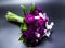 Beautiful bouquet of bride purple flowers on a dark background.