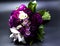 Beautiful bouquet of bride purple flowers on a dark background.