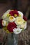 Beautiful bouquet in the form of a sphere, a bridal bouquet, flowers in a flowerpot against a dark background