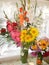 Beautiful bouquet of gladioli, roses and flowers of a sunflower, a vase of flowers