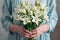 Beautiful bouquet of lilies held delicately in womans hands