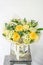 Beautiful bouquet of mixed flowers in glass vase. The work of the florist at a flower shop. Delivery fresh cut flower