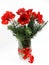 A beautiful bouquet of red amaryllis and conifer branches in a glass vase