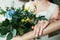 Beautiful bouquet of roses and bride`s hand with ring