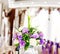 Beautiful bouquet in a vase. Purple and white flowers. The concept of a party and wedding decor.