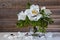 Beautiful bouquet of white flowers of peony Paeonia suffruticosa on a wooden background