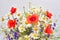 Beautiful bouquet of wild flowers daisies, poppies and consolida regalis on white background