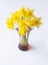 Beautiful bouquet of yellow narcisus flowers in a glass vase.