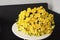 Beautiful bouquet of yellow rose bushes on a white table