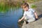 Beautiful boy pours water from the palm