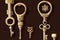 Beautiful brass vintage keys with ornament on dark brown background.