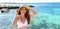 Beautiful Brazilian Caucasian woman smiling relaxing on summer beach sunbathing banner panorama