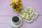 Beautiful breakfast on pink wooden background. Cup of coffee and marshmallows. Concept of romance and tenderness