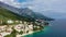 Beautiful Brela on Makarska riviera, Croatia. Adriatic Sea with amazing turquoise clean water and white sand. Aerial view of Brela