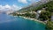 Beautiful Brela on Makarska riviera, Croatia. Adriatic Sea with amazing turquoise clean water and white sand. Aerial view of Brela