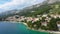 Beautiful Brela on Makarska riviera, Croatia. Adriatic Sea with amazing turquoise clean water and white sand. Aerial view of Brela