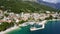 Beautiful Brela on Makarska riviera, Croatia. Adriatic Sea with amazing turquoise clean water and white sand. Aerial view of Brela