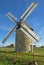 Beautiful Breton Windmill fully restored with sails on a sunny day and bright blue sky