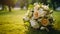 Beautiful bridal bouquet on a green lawn