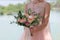 Beautiful bridal bouquet in hands of the bride. Wedding bouquet of peach roses by David Austin, single-head pink rose aqua, eucal