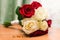 Beautiful bridal bouquet of white and red roses and gold wedding rings
