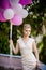 Beautiful bride with balloons before wedding ceremony