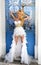 Beautiful bride blonde female model in amazing wedding dress poses on the island of Santorini in Greece