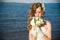 Beautiful bride with a bouquet of calla lilies on coast of river