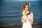 Beautiful bride with a bouquet of calla lilies on coast of river