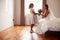 Beautiful Bride With Bridesmaid In Bedroom