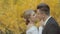 Beautiful bride corrects bow tie groom and they