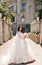 beautiful bride with dark hair in luxurious wedding dress in elegant villa