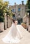 beautiful bride with dark hair in luxurious wedding dress in elegant villa