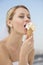 Beautiful Bride Eating Ice Cream Against Sky