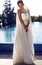 Beautiful bride in elegant dress posing beside s swimming pool