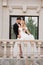 Beautiful bride and groom blonde on the balcony of a classic building.