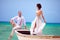 Beautiful bride and groom in boat swimming at caribbean sea